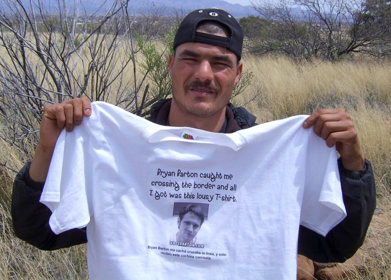 A Mexican migrant holds the T-shirt of B