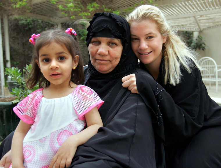 Marla Ruzicka, right, with an Iraqi family on Friday in Baghdad.