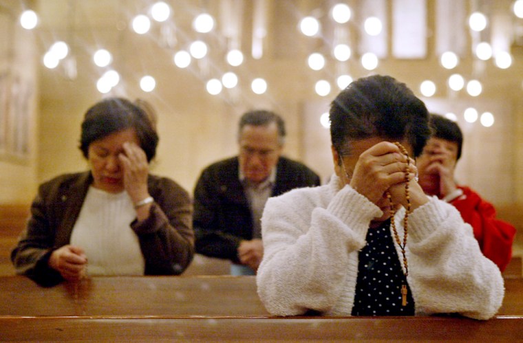 Catholics pray early Monday, April 18, 2005, at the Cathedral of Our Lady of the Angels in Los Angeles. The cathedral was open all night Sunday through Monday morning for a special prayer vigil for the election of the new Pope. (AP Photo/Ric Francis)