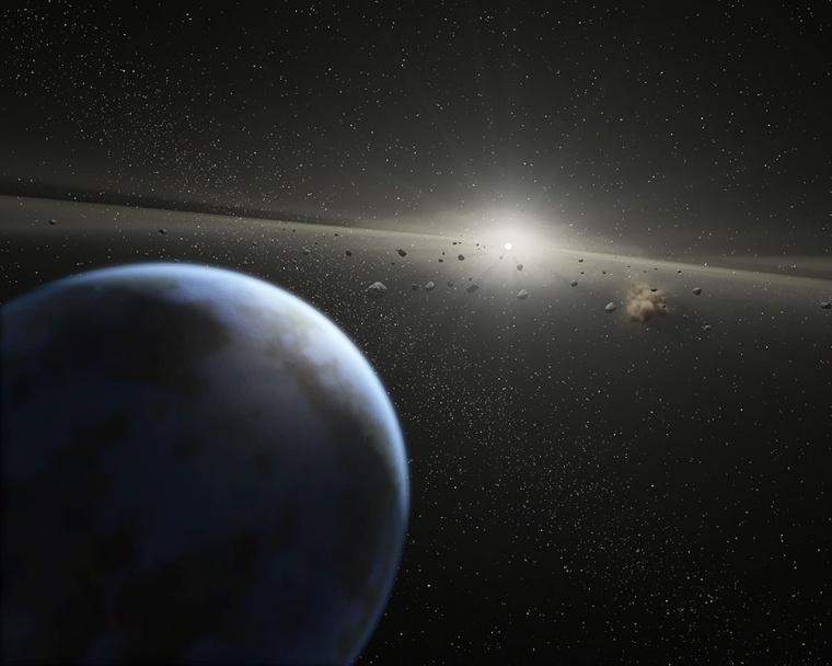 An artist's conception shows the haze of a thick asteroid belt around the star HD 69830, with a blue planet in the foreground. Scientists believe such an asteroid belt could hint at the presence of Earthlike planets.
