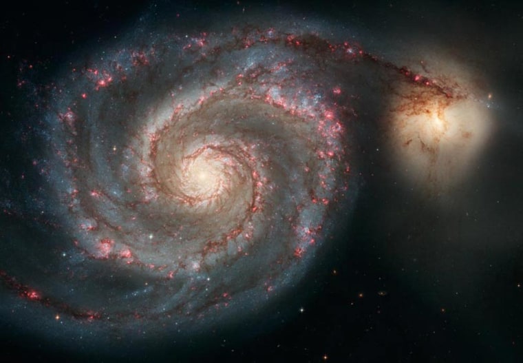 This picture of the Whirlpool Galaxy, or M51, shows how the gravitational pull of a smaller yellowish galaxy, known as NGC 5195, pumps up waves of starbirth as it passes by.