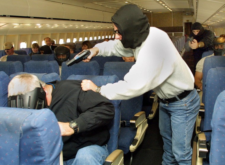 Federal Air Marshals perform tactical training inside a retired Lockheed L-1011 wide-body aircraft in this Sept. 26, 2001 photo. 