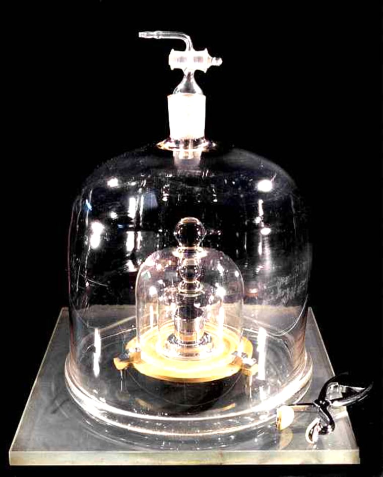 The mass of the kilogram is defined by the plum-sized cylinder of platinum-iridium alloy inside this series of jars, kept at a Paris institution.