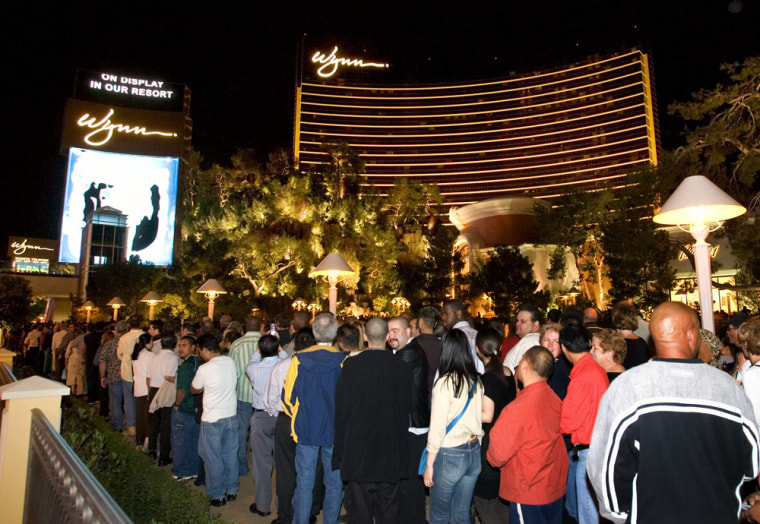 Thousands of people line up on the sidewalk on the Las Vegas Strip while waiting to get into the newly-opened Wynn Las Vegas just after the $2.7 billion resort opened to the public at midnight