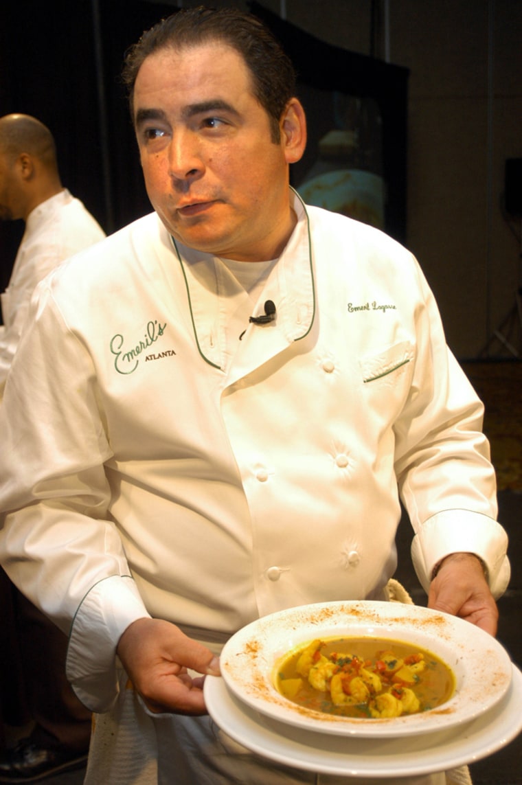 Chef Emeril Lagasse presents his golden shrimp stew after a cooking demonstration in New Orleans, April 27, 2005. (Jody will fix cut). (AP PHOTO/CHERYL GERBER)