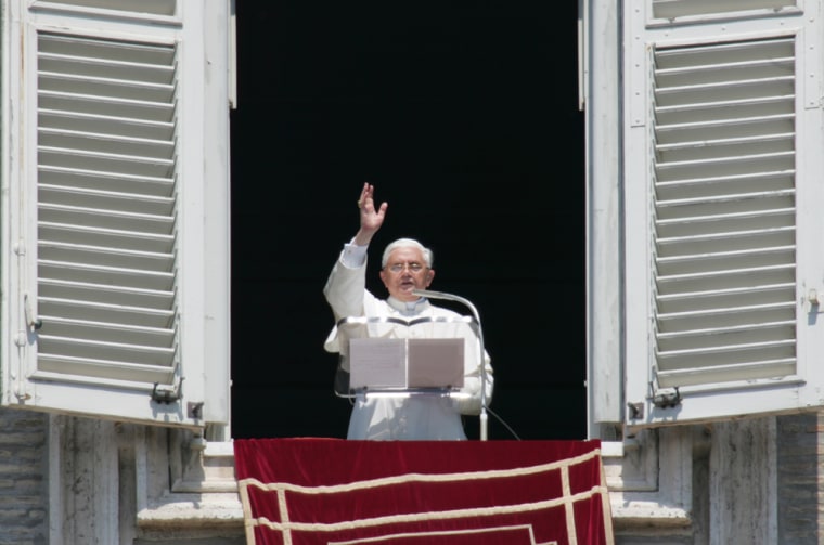 Pope Benedict XVI blesses the faithful as he makes the first appearance of his papacy at the window of his apartment overlooking St. Peter's Square at the Vatican, for the Sunday Angelus prayer.