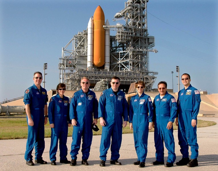 Space Shuttle Discovery astronauts pose at launch pad during countdown test