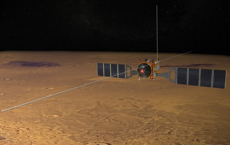 An artist's conception shows the Mars Express orbiter circling Mars with its long MARSIS radar booms fully extended. The longest booms stretch out 65 feet.
