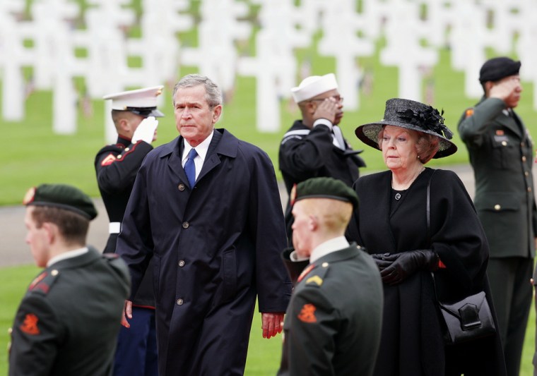 U.S. President George W. Bush and Queen Beatrix of the Netherlands walk between an honor cordon of U.S. and Netherlands military as Bush arrives for a visit to the Netherlands American Cemetery