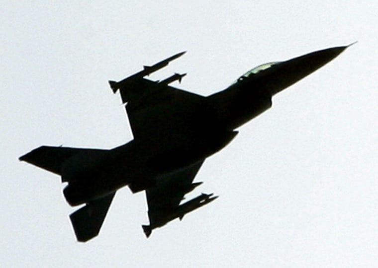 An F-16 fighter jet, fully armed with air-to-air missiles under its wings, maneuvers above the northwest section of Washington D.C., Wednesday, May 11, 2005, near a cluster of embassies from Middle Eastern nations as it and at least one other F-16 scrambled to intercept a small airplane that flew into the restricted airspace that circles the nation's capital.  The White House and the Capital were evacuated until the situation with the small plane was resolved. (AP Photo/J. Scott Applewhite)
