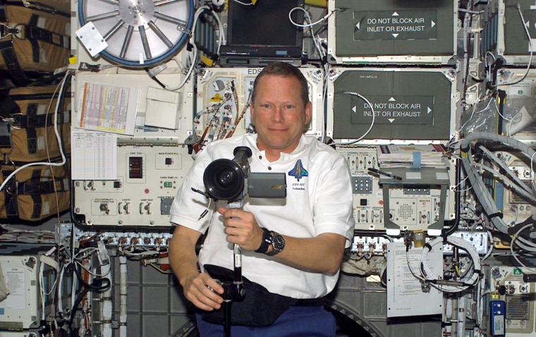 Astronaut David Brown steadies his digital video camera aboard Columbia in January 2003, during the space shuttle's final mission. A new documentary, "Astronaut Diaries," draws upon hundreds of hours of video footage shot by Brown during training for the flight.