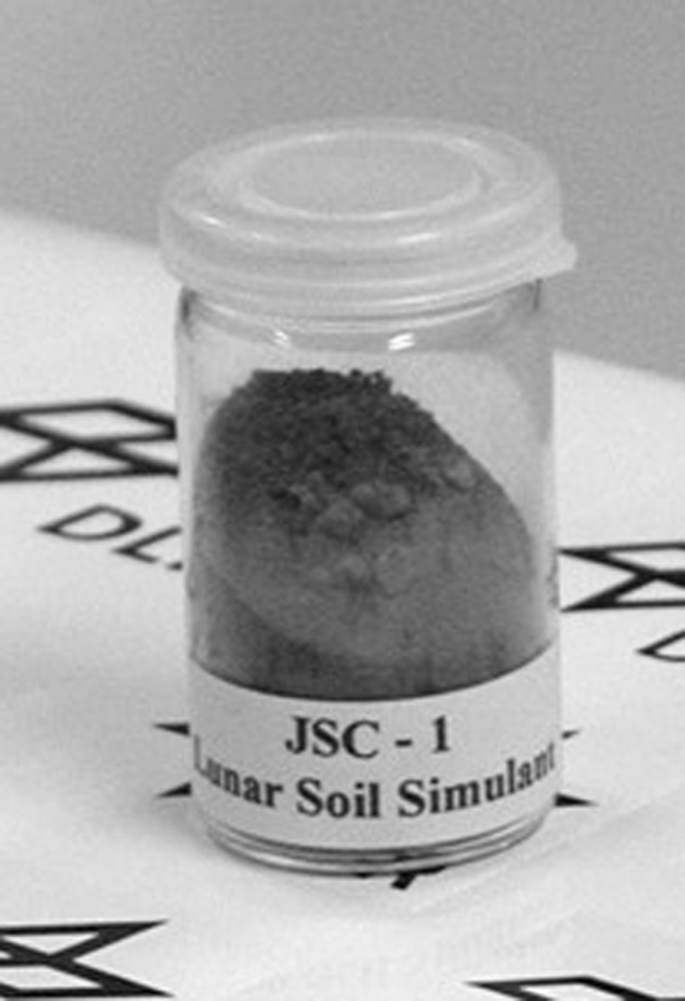 A container holds a sample of JSC-1, simulated moon soil that is made by NASA for test purposes. The simulant would be used to produce oxygen in the MoonROx contest.