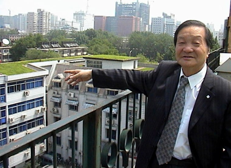 Wang Xianmin points to an example of his 'green rooftop project' in Beijing.