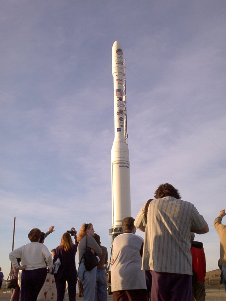 Onlookers await the launch of a rocket that carried cremated remains into orbit on Sept. 21, 2001.  Space Services Inc. plans to launch its fifth memorial flight this summer amid a growing trend in personalized funerals.