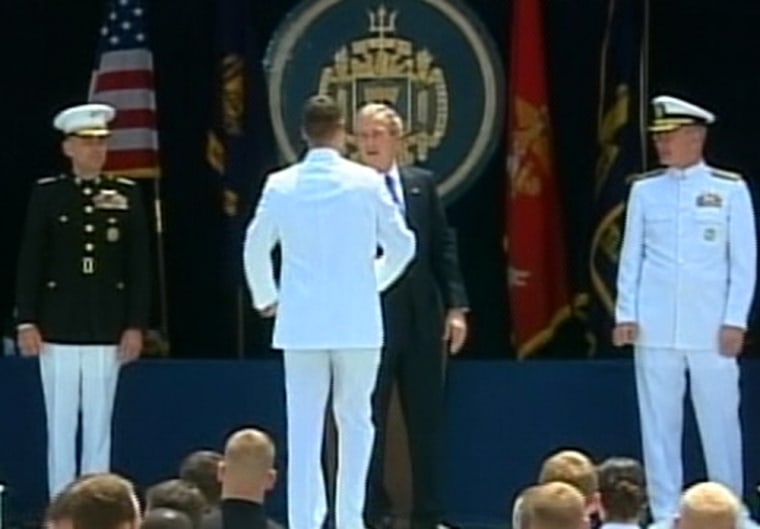 President Bush congratulates a graduate at the Naval Academy commencement ceremony Friday.