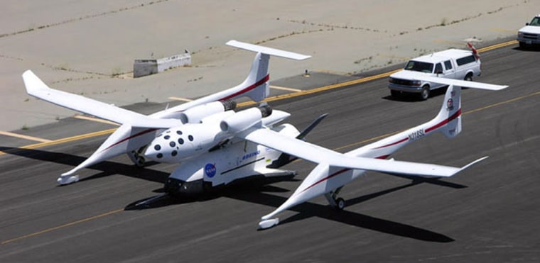 During runway tests in Mojave, Calif., the X-37 space plane is tucked beneath Scaled Composites' White Knight carrier airplane — in the position where the SpaceShipOne craft nestled. 