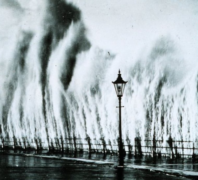 A wave from the 1938 hurricane strikes a seawall in New England.