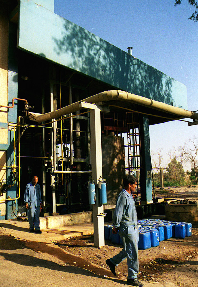 Workers are seen at the Al-Qaa Qaa plant, where centralite, a military chemical was produced, in this Sept. 24, 2002, file photo. The plant is in Ramadi, about 25 miles east of Baghdad.