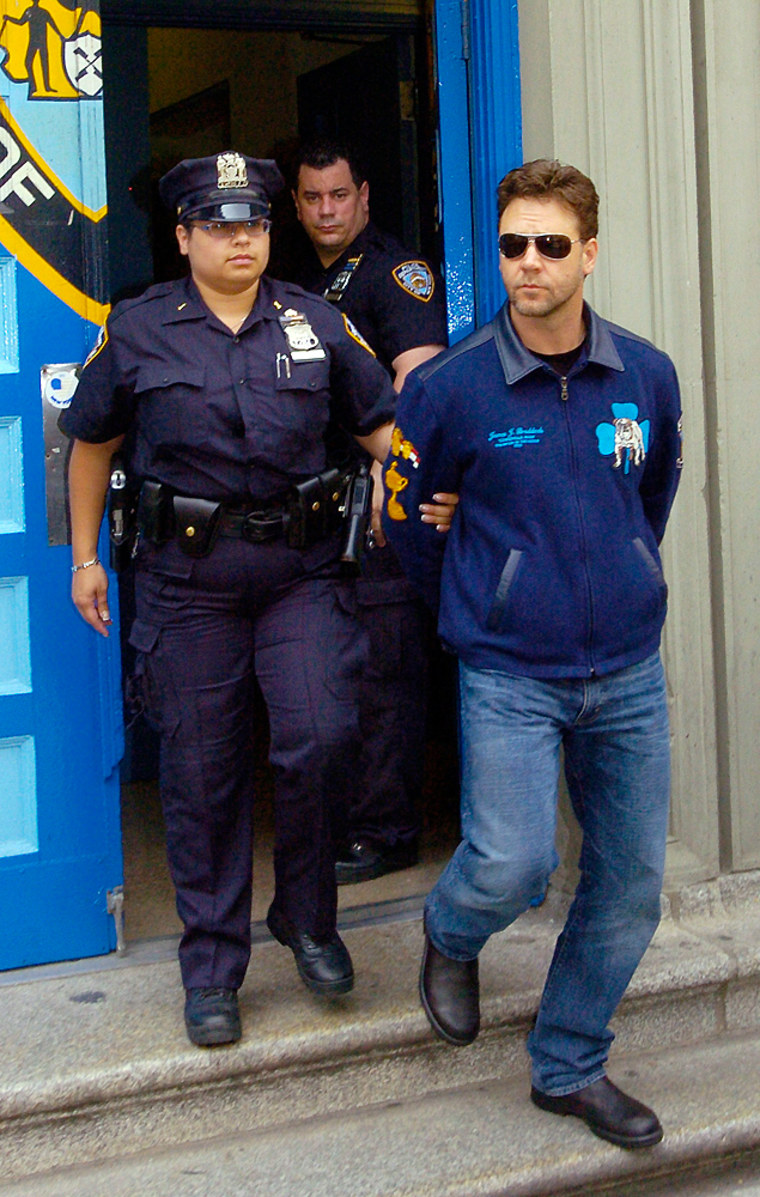 Russell Crowe is walked out of police station by police after arrest in New York City