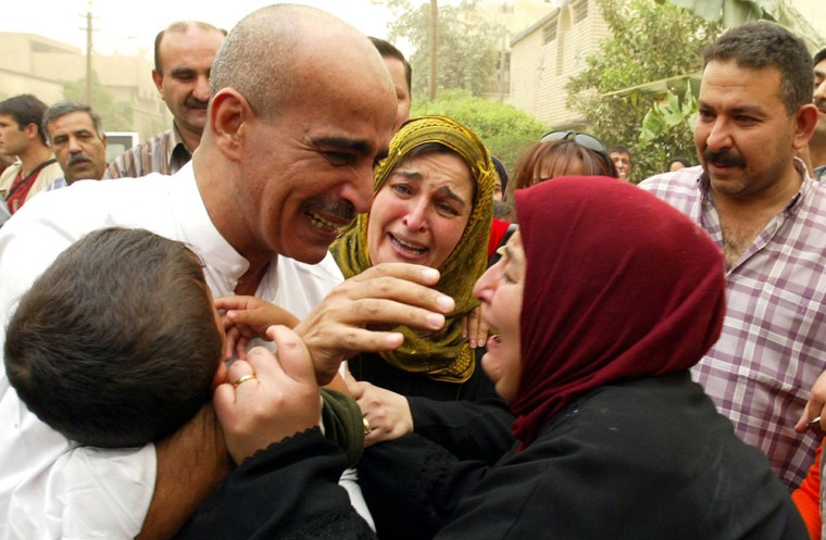 Iraqi interpreter Hussein Hanun (L) grab