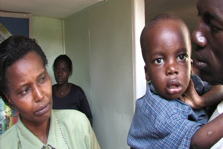 Two and a half year old Ian with Dorcas Githinji, coordinator of the Thika Nursing Center, a health clinic outside of Nairobi that treats HIV/ AIDS patients, but it has not qualified for international aid, so they do not have access to antiretroviral drugs for the treatment of AIDS. Ian became one of the many young victims of AIDS and died shortly after this photo was taken.