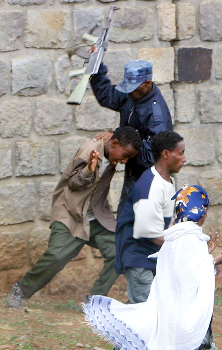 An Ethiopian policeman beats a university student in Addis Ababa on June 6 amid political protests.