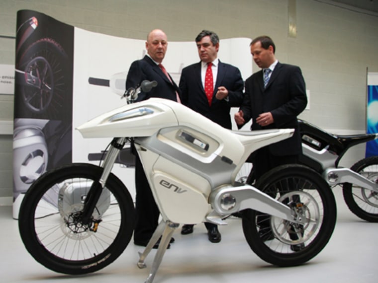 Unveiled in London earlier this year, the ENV fuel cell motorcycle is shown here to British Chancellor Gordon Brown, center, and Member of Parliament Andy Reed, right. At left is Intelligent Energy CEO Harry Bradbury.