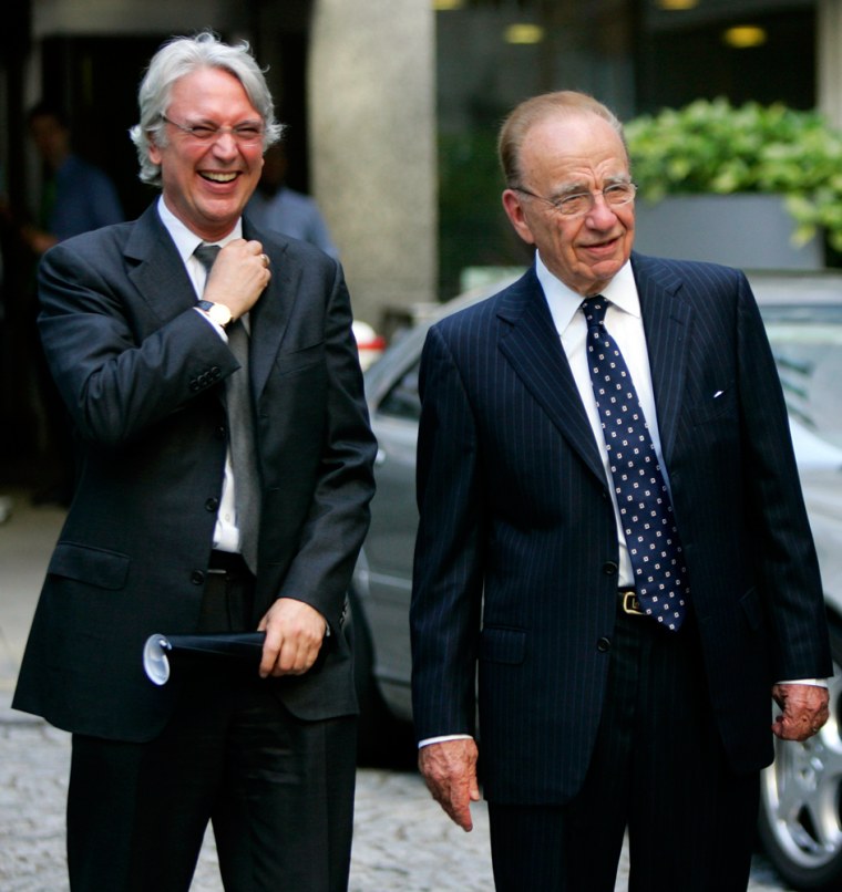 Media mogels Rupert Murdoch, right, and Les Hinton, leave a service held at St. Bride's Church in London on Wednesday to mark Reuters' departure from Fleet Street, the heart of British journalism for more than 300 years.