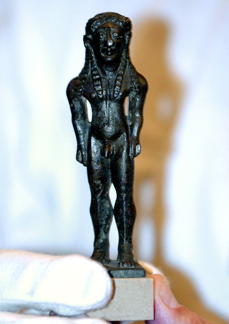 A 2,600-year-old bronze statuette of a youth is displayed at the Culture Ministry in Athens on Thursday. A British ancient art dealer returned the tiny 2,600-year-old statue to Greek authorities, after realizing the piece had been stolen from the island of Samos during World War II.