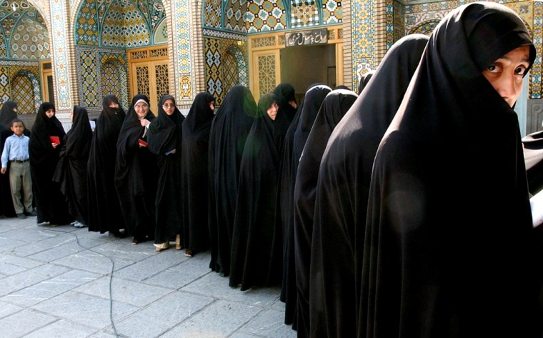 Iranian women stand in line to cast their votes for the Iranian presidential elections at the Masoumeh shrine in the city of Qum on Friday.