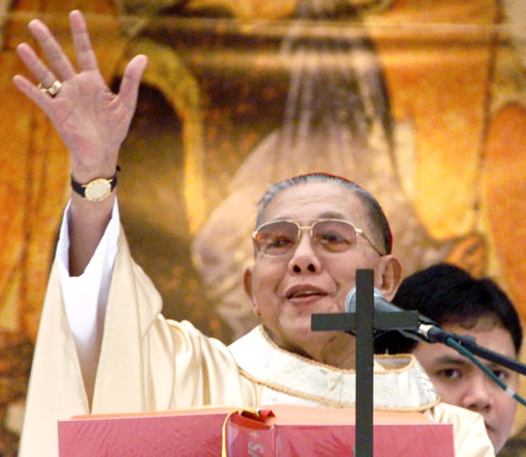 Filipino Cardinal Sin, the then Archbishop of Manila, waves to the crowd during a prayer rally in Manila