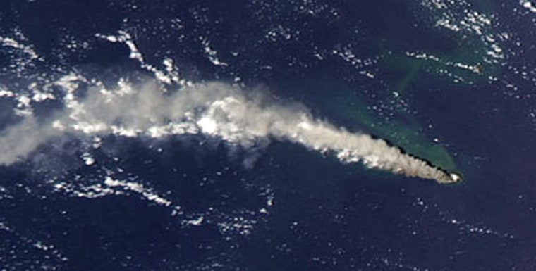A photo taken Monday by an imager on NASA's Aqua satellite shows the ash plume sweeping westward across the Pacific from the Anatahan Volcano.