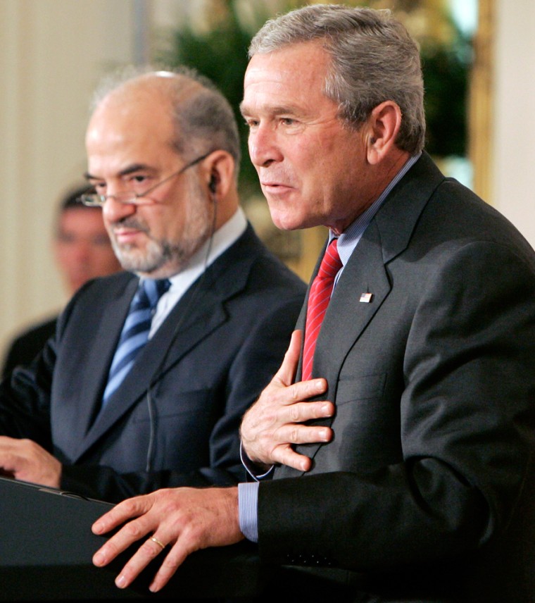 US President Bush puts hand on chest during joint news conference with Iraqi Prime Minister al Jaafari at White House