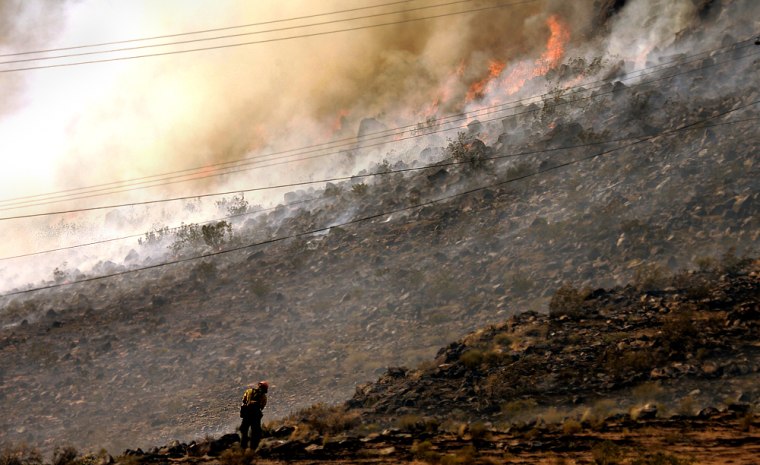 This fire in St. George, Utah, was one of 21 large blazes across the West during the last week of June 2005. Some experts tie an increase in fires in recent years to warming and drought.