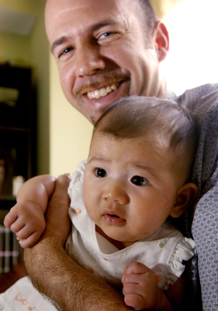 Tom Loftus with his daughter Nora in his New York City apartment. *** pregnancy package ***