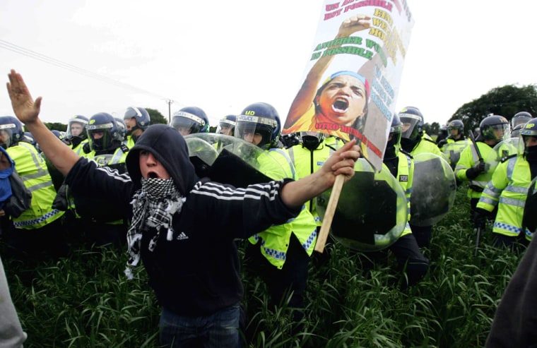 Riot police officers force anti-G8 prote