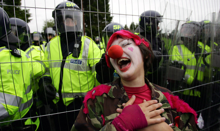 An anti-G8 protester dressed as a clown
