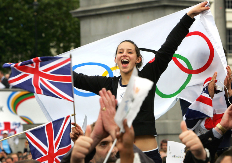 A girl celebrates with Olympic flag as t
