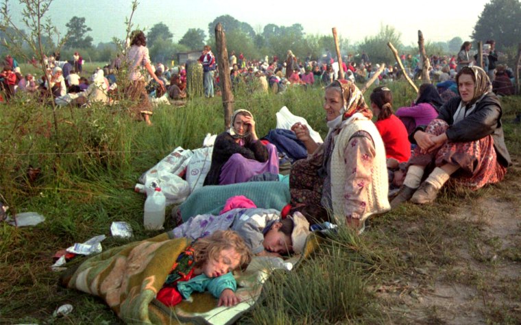 Refugees from Srebrenica gather outside the U.N. base at Tuzla airport on July 14, 1995, amid the massacre of 8,000 Bosnian men and boys from their town.