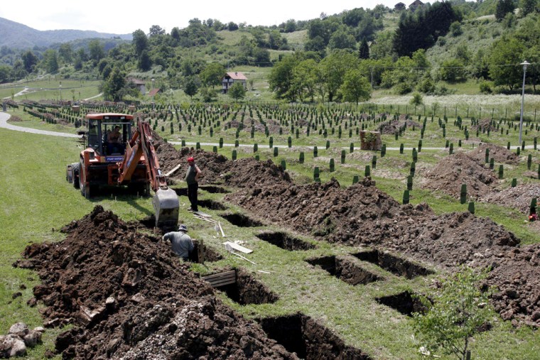 ** ADVANCE FOR Sunday, July 10 **Workers dig new graves at the Srebrenica Memorial Center in Potocari on Wednesday, July 6, 2005. Preparations for next week's anniversary of the 1995 massacre here includes the burial of 613 victims, found in mass graves throughout eastern Bosnia. When Serb forces marched into the Muslim town of Srebrenica at the end of Bosnia's 1992-95 war, the population fled to nearby Potocari to seek protection in the compound of the United Nations peacekeepers. But the peacekeepers were unable to prevent the troops from entering the compound and separating the men from the women. The women were expelled to Muslim-held territory and some 8,000 men were summarily executed in the worst massacre in Europe after World War II.  (AP Photo/Hidajet Delic)