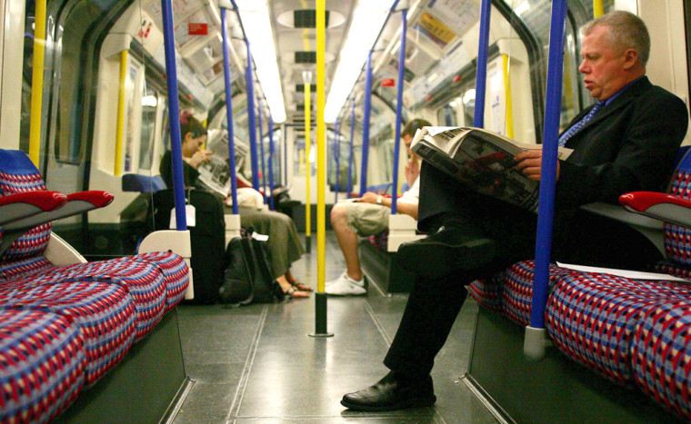 Passengers travel on the London Underground the day after four explosions were detonated in London