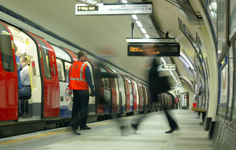A rush hour passenger walks along an unusually empty platform at Kennington Tube Station, in London, on Friday.