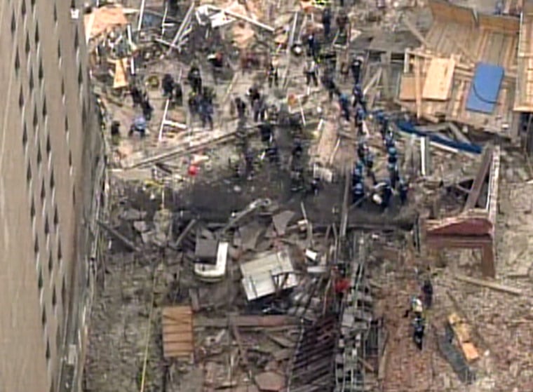 Firefighters search for victims in the rubble of a collapsed building in Manhattan on Thursday.