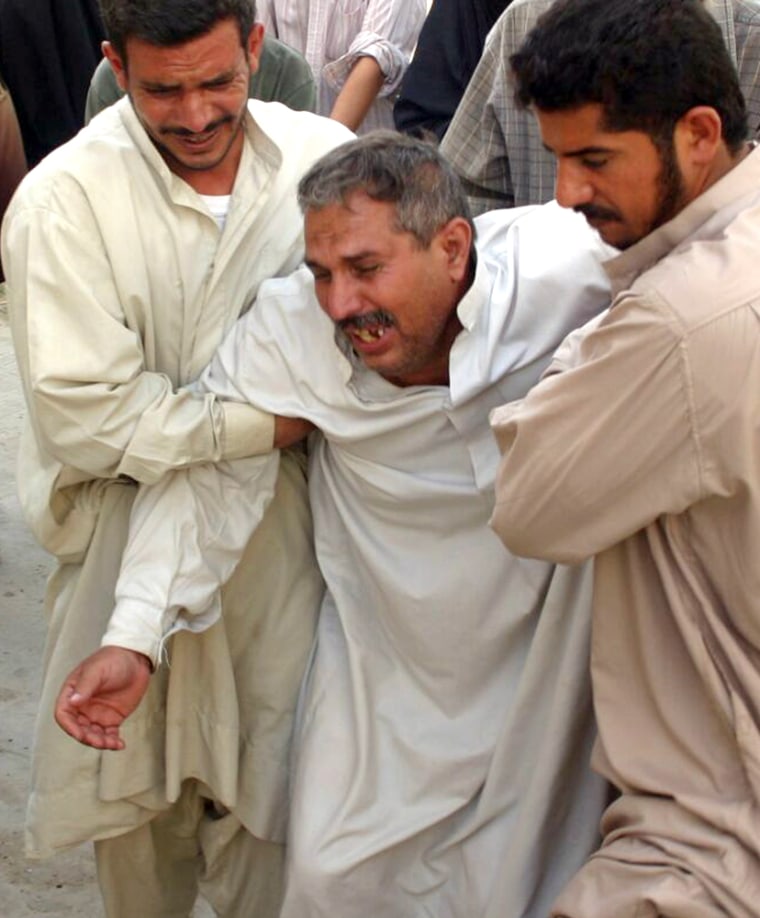 Man breaks down as he grieves for relatives killed in suicide bomb attack in Musayyib
