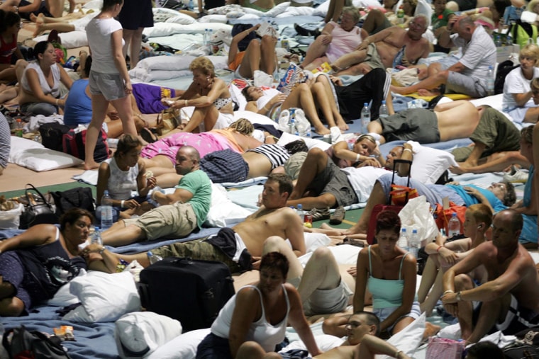 Stranded tourists rest at a refuge center as they wait for Hurricane Emily in Mexico