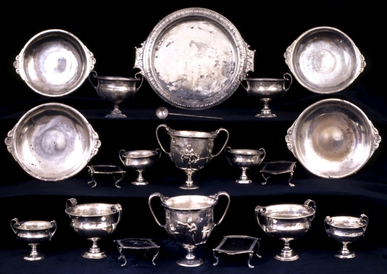 Decorated cups and silver platters are displayed after being unearthed from the ruins of the 2,000 year old volcanic eruption of ancient Pompeii