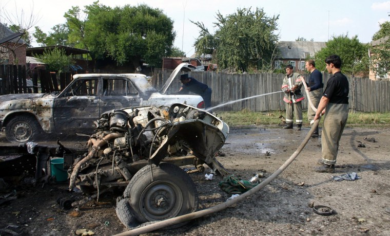 Chechen firemen extinguish the rubble of