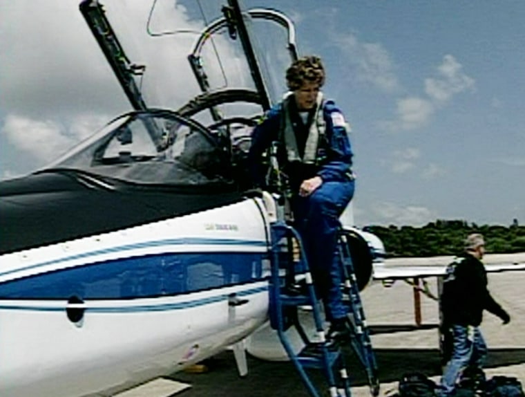 Discovery commander Eileen Collins descends from her T-38 training jet after landing Friday at NASA's Kennedy Space Center in Florida. Collins and her crewmates made a brief trip to Houston for training while they waited for Discovery's next launch attempt.