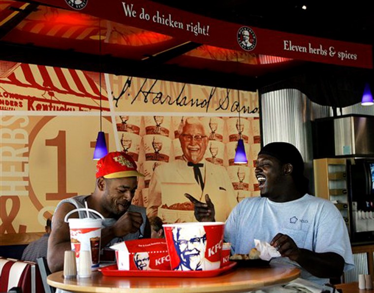 Desmond Anderson, left, and Nathaniel Sparks enjoy a light moment as they share a bucket of KFC chicken during their lunch hour at a Louisville, Ky., restaurant. The handwritten recipe that launched the fast-food dynasty is locked away at the KFC headquarters. 