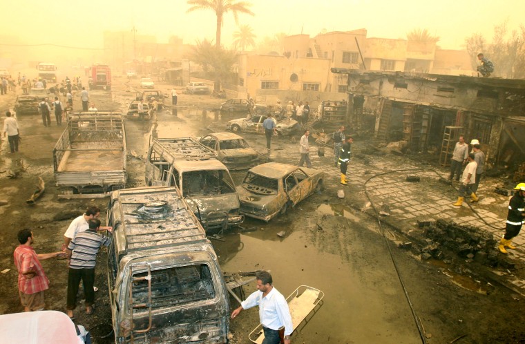 Burnt out trucks and cars are strewn alo